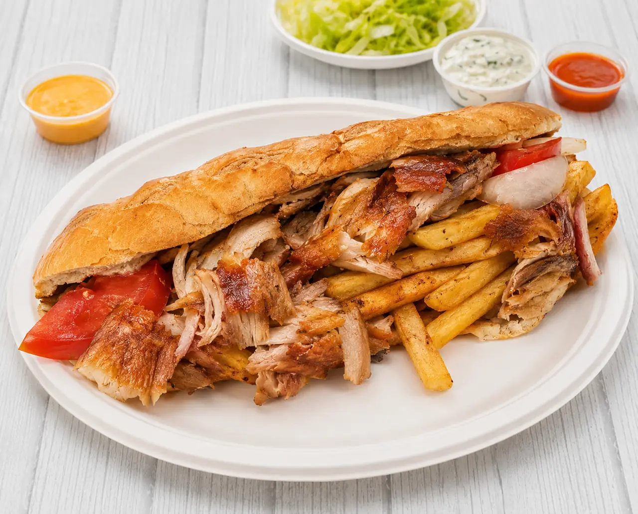 Pitta filled with gyros and fries, served with dips